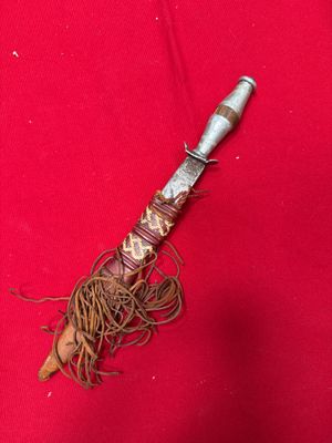 a close up of a knife on a red cloth on a table