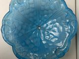 a blue glass bowl sitting on a white door