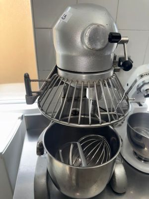 a mixer and a bowl on the counter in the kitchen