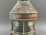 an old, rusted, metal lamp with a glass dome on top