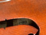 a close up of a guitar strap on a wooden table