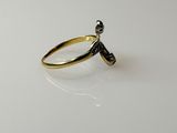 a close up of a gold ring with a diamond on it