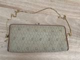 the purse is sitting on a wooden floor with a chain around it
