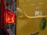 a close up of a yellow car with a sticker on it