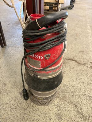 a keg with a hose attached to it in the garage