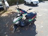 a scooter that is parked on the side of the road