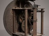 an old clock that is sitting on a stand