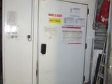 two white doors in a garage with a red fire hydrant