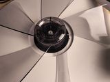 a fan sitting on top of a table next to a cell phone