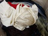 a pile of clothes in a suitcase on the floor