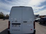 the back of a white van is parked in a parking lot