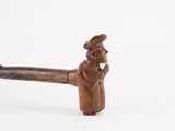 an old wooden pipe with a man in a hat and coat holding a pipe