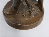 a bronze statue of a man with a dog