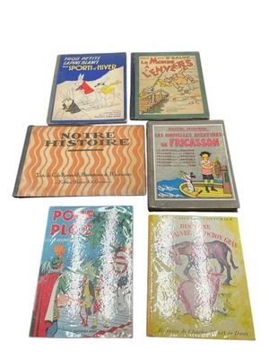 several children ' s books are lined up on a white surface