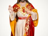 the statue of jesus is wearing a crown and standing on a cloud