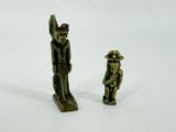 two figurines of a man and a woman standing next to each other