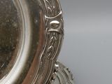 a silver plate on a silver plate on a gray surface