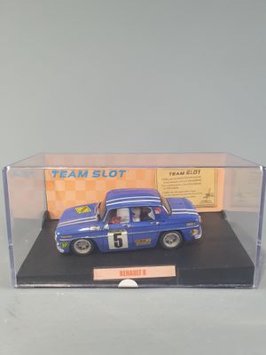 a blue toy car in a display case on a table