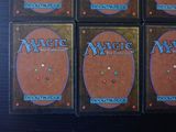 four decks of magic the gathering cards are sitting on a table