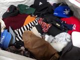 a box full of clothes and hats that are in it