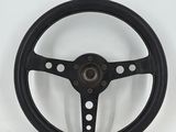 a black steering wheel on a white background