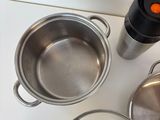 many pots and pans on the kitchen counter