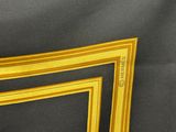 yellow and black picture frame on a black background with a yellow border