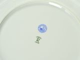 a white plate with a blue and green design on it