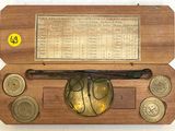 a wooden box with coins and a baseball bat on it