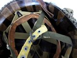 a close up of a helmet with a leather strap on it