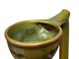 a green vase with a wooden handle on a white background