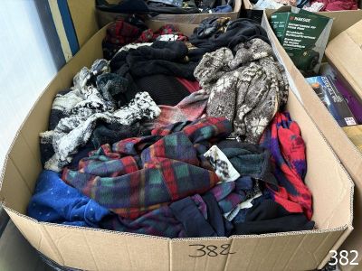 a cardboard box filled with clothes and other items