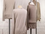 three mannequins on display in a room with white walls