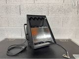 an image of a heater sitting on top of a table next to a brick wall