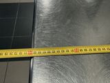 a measuring tape that is on top of a metal table