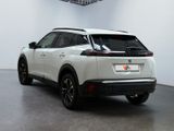 the rear end of a white nissan suv parked in a room
