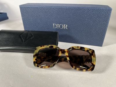 a close up of a pair of sunglasses on a table next to a box