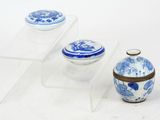two blue and white vases sitting on a clear shelf