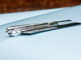 a close up of a pair of scissors on the hood of a blue car
