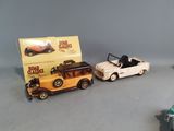 two toy cars sitting next to each other on a table