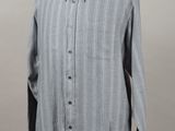 the shirt is on a mannequin stand with a gray background