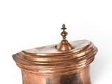 a small copper box with a lid on a white surface