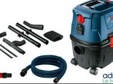 a blue vacuum cleaner with a hose and other tools