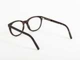 a close up of a pair of glasses on a white surface