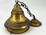 an old brass bell with a chain hanging from it ' s neck