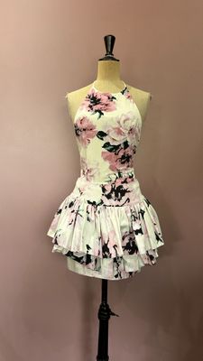 pink and black floral dress on a mannequin stand