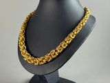 a close up of a mannequin with a gold chain on it