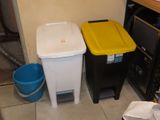 two trash cans sitting next to each other on the floor