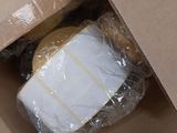 a box with a sandwich in it that is wrapped in plastic