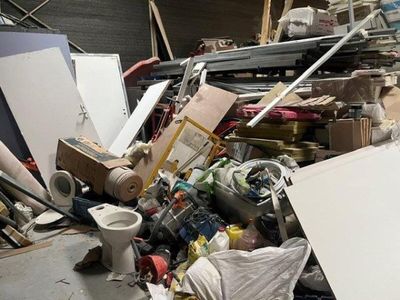 a pile of junk in a room with a toilet and other items